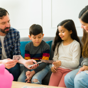 An image of a father giving money to her daughter. Son and mother is also included in the image.