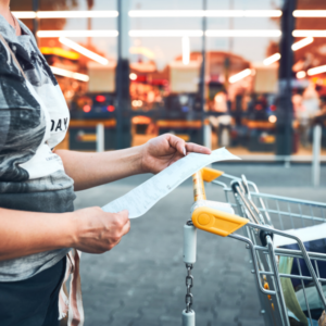 Woman looking at higher prices on receipt after shopping in