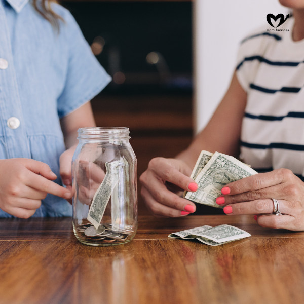 Child Counting Money from Glass Jar with Mother